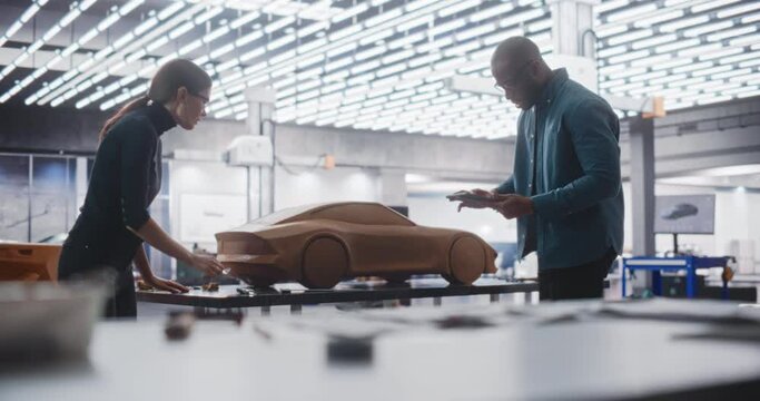 Enthusiastic Teamwork of Two Diverse Creative Colleagues Working in an Automotive Development Design Agency. Professional Sculptor Working Together with an Engineer, Team Perform a High Five