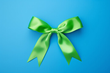 Tied bright green ribbon on blue background