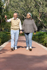 Smiling senior couple enjoying view of nature at public park