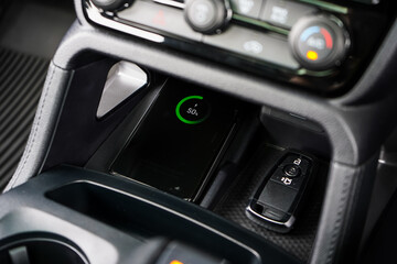 Wireless mobile charger in the modern car. Portable wireless car charger for smartphone.	
