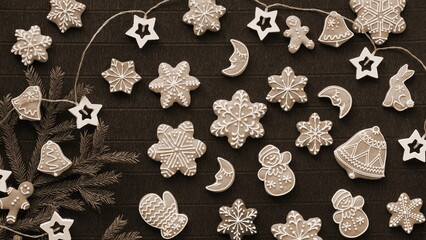 Delicious Gingerbreads Black Background and a Natural Pine Branch. Top View. Sharp focus. Sepia...
