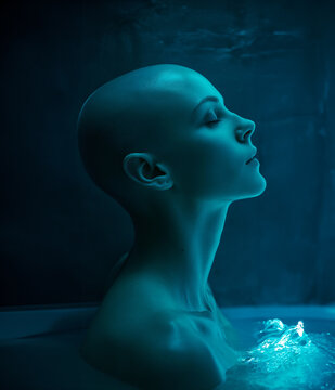 Woman in a cryogenic chamber tube - Blue glow - Sci-fi concept - Technology concept - Futuristic Concept - Medical Science Concept - The Blue Horizon