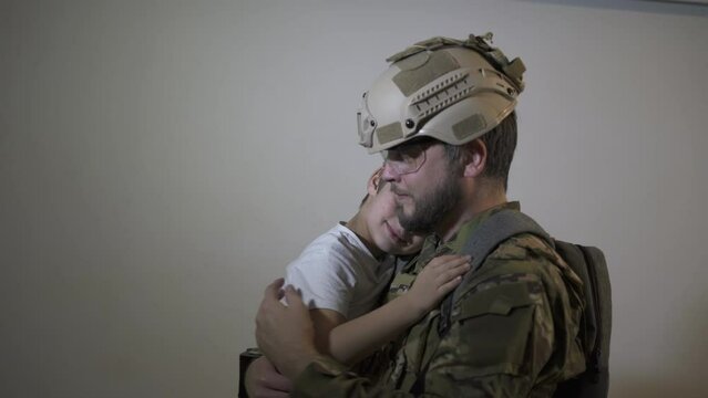 A soldier and his boy child son say goodbye