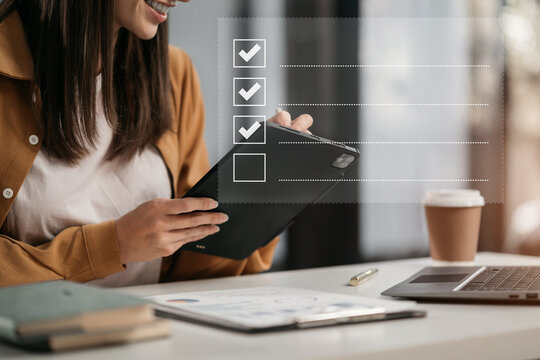 Business woman using tablet to do online checklist survey, doing assessment online survey answer test questions Digital form.