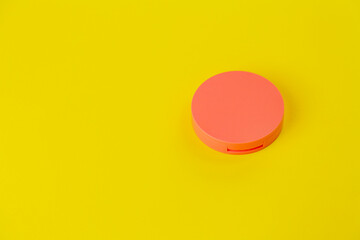 Pot of cream on yellow background. Pot concept. Beauty product concept. Space for text. Mockup.