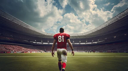Fotobehang From the back, an American football player walks through the stadium. © OleksandrZastrozhnov