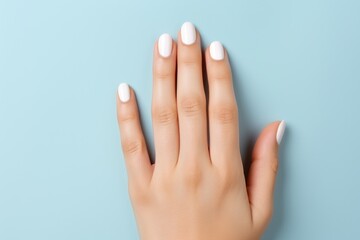 Young woman hands with white nails on light blue background. AI Generated