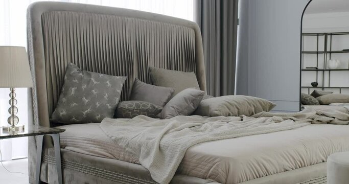 Neoclassical Interior of modern luxury bedroom. Elegance interior design. Minimalist Brown Bedroom. Modern Bedroom Interior and bed with many pillows. Minimalistic scandinavian style of interior.