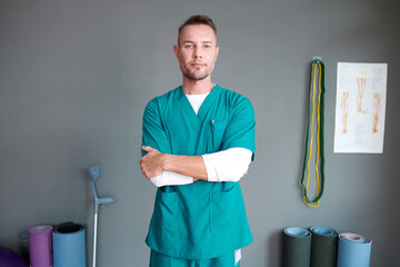 Portrait of confident orthopedist working in rehabilitation center - obrazy, fototapety, plakaty