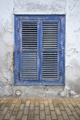 Colorful old wooden house shutters.
Wooden shutters of old stone houses.