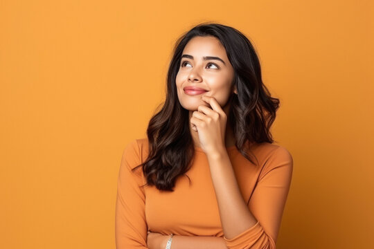 young indian woman thinking on isolated background