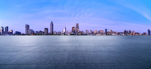 Poster City Square floor and Shanghai skyline with modern buildings at dusk. Famous Bund architectural scenery in Shanghai. Panoramic view. © ABCDstock