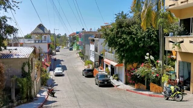Typical beautiful colorful tourist street sidewalk city Puerto Escondido Mexico.