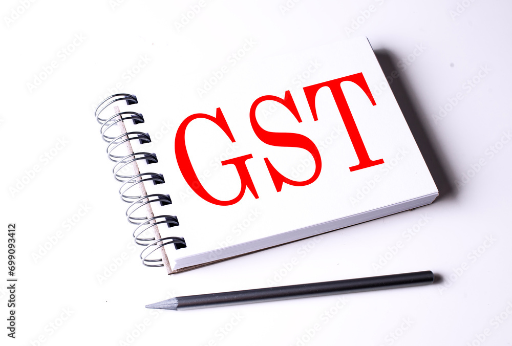 Poster text gst on notebook on the white background