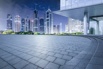City square floor and modern commercial buildings at night in Shanghai
