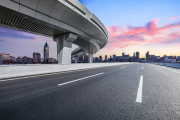 Fototapeten Asphalt road and pedestrian bridge with modern buildings in Shanghai © ABCDstock