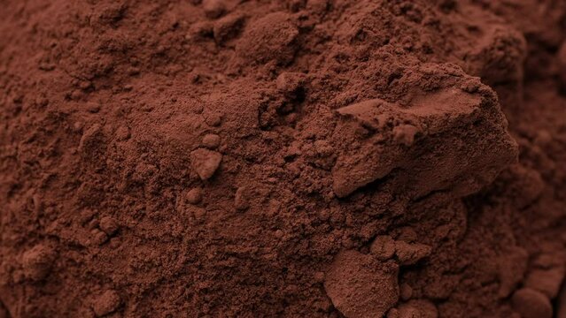 Heap of cocoa powder close up, rotation. Confectioner prepares ingredient for dessert, sauce