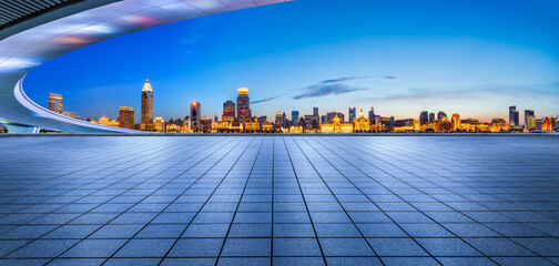 Empty square floor and bridge with Shanghai skyline at night. Panoramic view.
