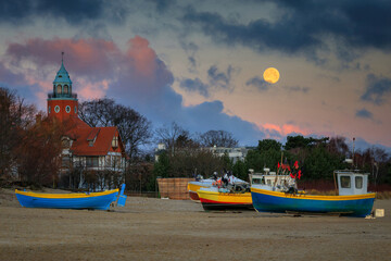 Fishing boats on the beach of Baltic Sea in Sopot with the full moon, Poland