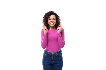 pretty smiling young curly brunette woman dressed in purple turtleneck