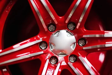 Fotobehang new alloy car wheel closeup, red color © soleg