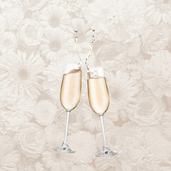 Two champagne glasses with neutral background