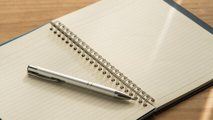 Open notebook and pen on the desk