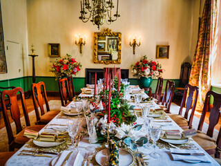 christmas lunch decor on a dinning table in a vintage room with antique victorian furniture and...