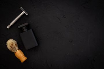 Black perfume bottle for man with shaving accessories