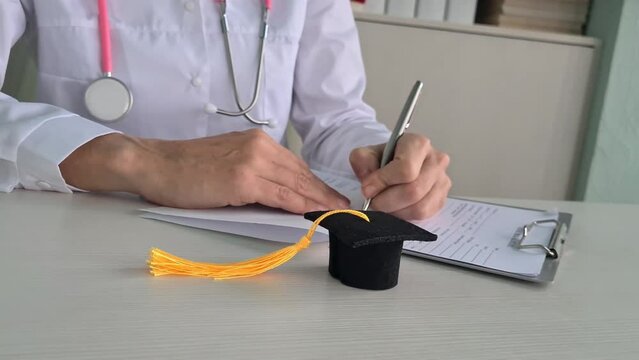 Doctoral study student with graduation hat in hospital room. Smart genius concept of medicine education and training