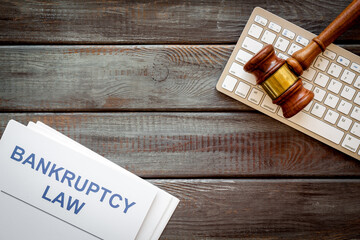 Bankruptcy law concept. Wooden judge gavel and keyboard, top view
