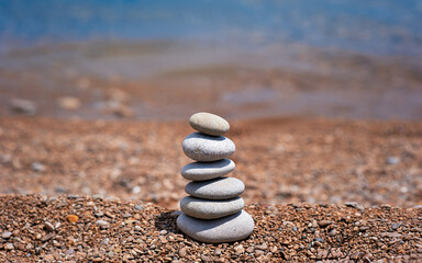 Stack of pebble stones with sea on the background
