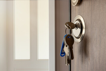 Open door to a new home. Door handle with keys. Mortgage, investment, real estate, property and new...