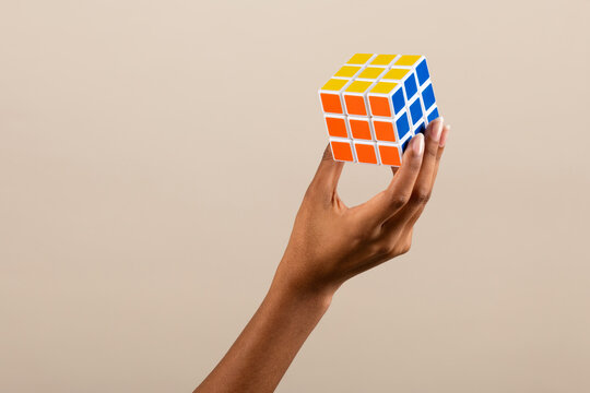 Crop black woman showing 3D rubiks cube puzzle