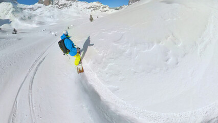 SELFIE: Male snowboarder on a joyful ride down the untacked snowy mountains