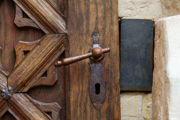 antique iron handle on the background of a wooden door
