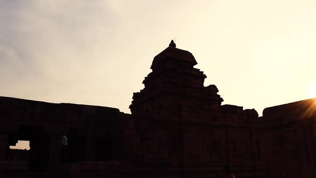 Cinematic view of Pattadakal temples during sunset with rays of divine light.