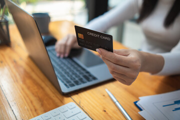 business woman is using credit card to pay for products online when ordering products from store through an online website because using credit card to pay for products brings convenience in shopping
