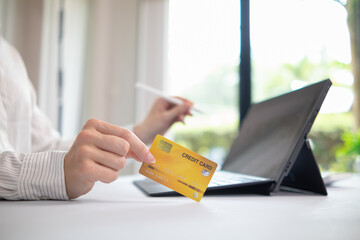 business woman is using credit card to pay for products online when ordering products from store through an online website because using credit card to pay for products brings convenience in shopping