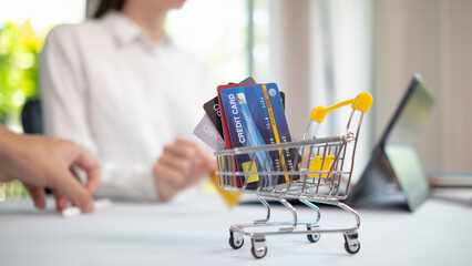Credit card are popularly used today era because they are convenient for purchasing products from regular stores and online stores can purchase products through application by paying with credit card. - obrazy, fototapety, plakaty