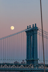 Manhattan bridge with full moon at dusk, new york city