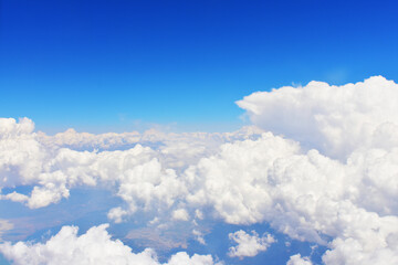 Blue sky with big white clouds, top view. Heavenly background