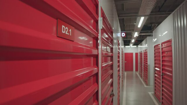 Close up shot of red steel door of storage unit with D2.1 sign in self-service warehouse