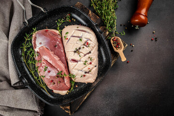 Raw duck fillet. in pan. Culinary, cooking, bakery concept. on a dark background. top view. copy...