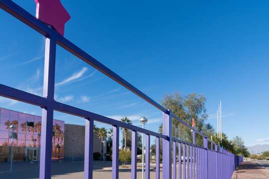 Tucson, Arizona - December 20, 2023: Colorful purple fence surrounds the abandoned Lisa Frank warehouse and office building