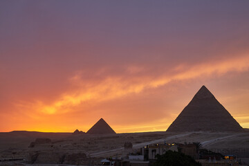 View of the Giza Pyramids during dramatic Sunset - obrazy, fototapety, plakaty