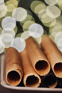 Neulas homemade on a plate typical thin biscuit rolls eaten at Christmas in Catalonia, Spain.

