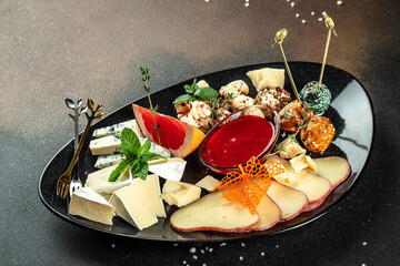 antipasti cheese platter on a dark background. top view. copy space for text