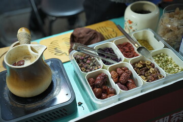 Roasted milk, a popular street food originating in Yunnan,china.  Milk boiled in a pot with tea and some other dried flower or nuts.

