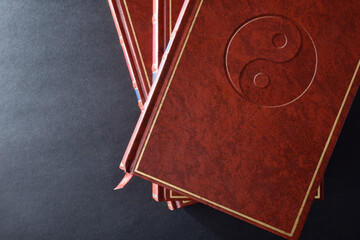 Stack of books with engraved symbol taoist top view